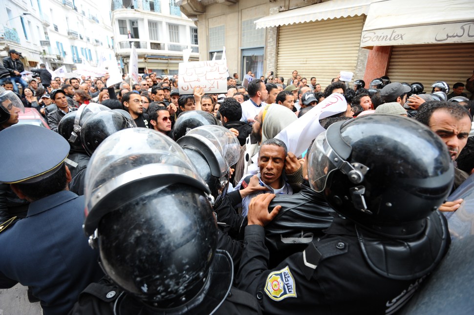 Police officers prevent unemployed Tunisians from protesting Ennahdha's Government, in Tunis on April 7, 2012.  (FETHI BELAID/AFP/GettyImages)