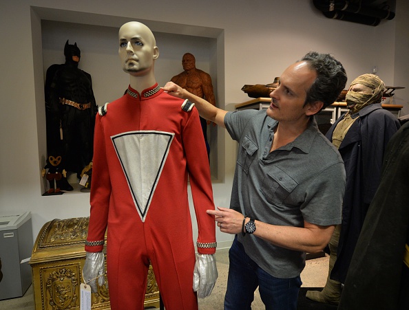 This photo taken on on September 18, 2014 shows auctioneer Brian Chanes with the original Robin Williams iconic 'Mork' spacesuit from the 1970's comedy show 'Mork and Mindy' that will be sold next month by auctioneers Profiles in History's at Calabasas, California. The suit is estimated to sell for more than USD$20.000 in the company's Hollywood auction that will take place from October 17-20. AFP PHOTO/Mark RALSTON (Photo by Mark Ralston/AFP/Getty Images)