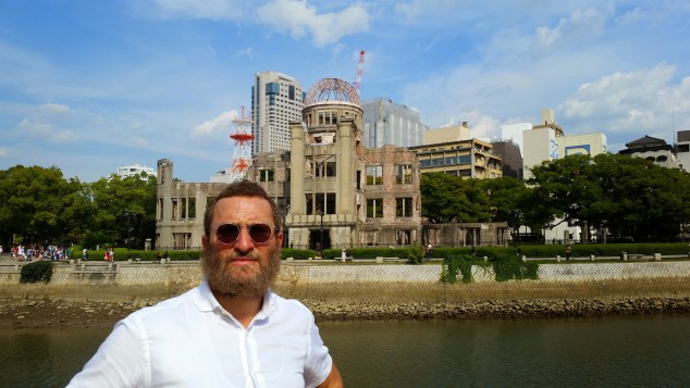 The author, during his trip to Hiroshima, with the Hiroshima Peace Memorial in the background (Photo courtesy Rabbi Shmuley Boteach)
