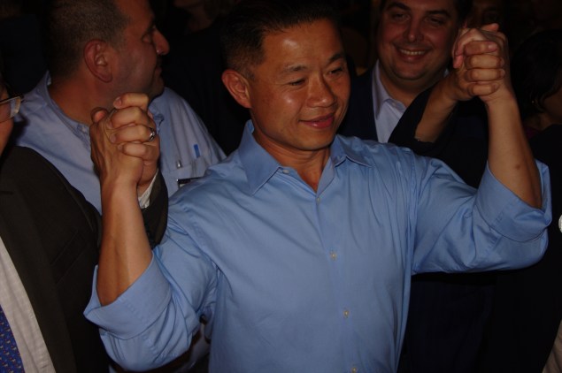 John Liu joins hands with supporters despite numbers showing him trailing Tony Avella (Photo: Will Bredderman).