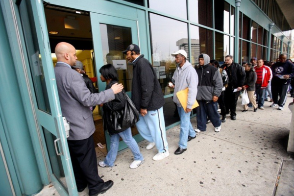 A security guard leads people into an unemployment center in Jersey City. NJ's job numbers are up this year, with 4.4 percent unemployment. (Photo: Jennifer Brown/The Star-Ledger)
