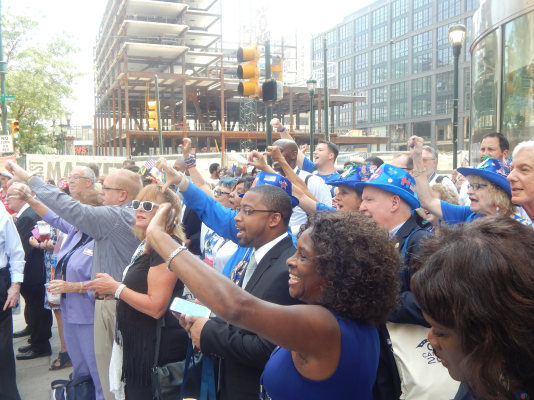 Clinton supporters on Broad Street give the thumbs down to a passing truck bearing anti-Clinton messages 
