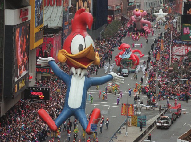 Woody Woodpecker leads a line of other balloons and floats  into New York's Times Square during the 69th annual Macy's Thanksgiving Day parade Thursday, Nov. 23, 1995. Kids of all ages, bundled against the 36-degree chill, lined the route to enjoy the  balloons, marching bands, singers and dancers, and other parade spectacles. (AP Photo/Paul Hurschmann)