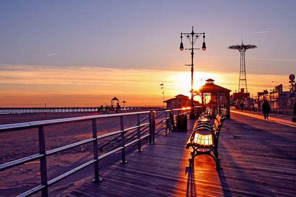 The sun sets over the Coney Island Boardwalk. (Credit: New York Habitat)
