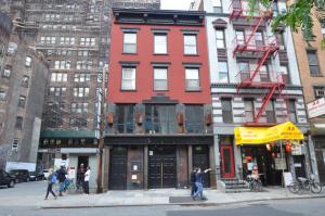 215 West 28th Street (in middle) and former parking lot at 219 West 28th Street (on left).