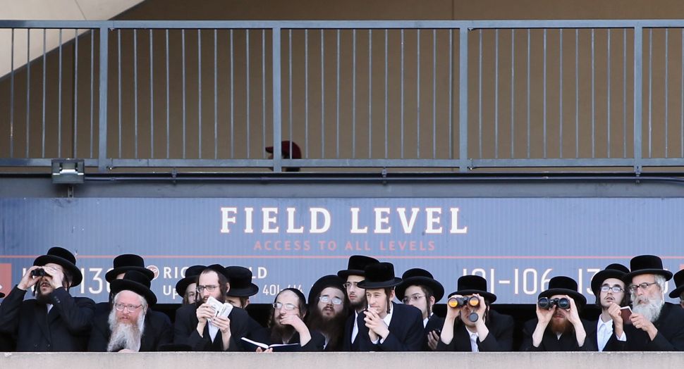 Ultra-Orthodox Jews take in the view from Citi Field at a meeting to discuss the risks of using the Internet on May 20, 2012. (Photo by Mario Tama/Getty Images)