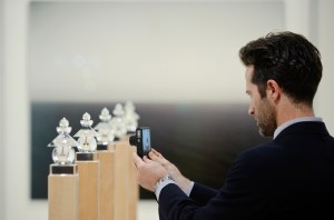 A visitor takes a picture of a work of a