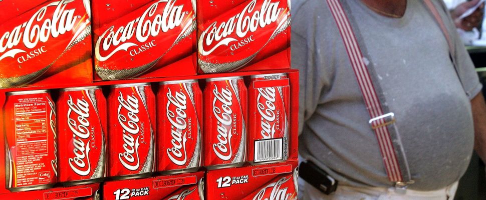 A man passes cartons of soda for sale in Des Plaines, Illinois.
