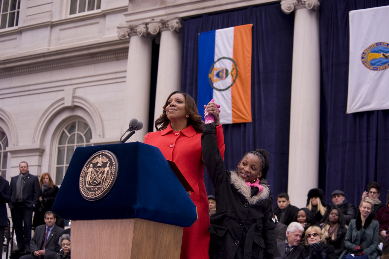 Public Advocate Letitia James with Dasani Coates at Mayor Bill de Blasio's inauguration, with former President Bill Clinton and former Secretary of State Hillary Clinton in the background (Photo: William Alatriste)