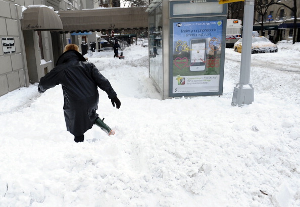 A pedestrian struggles to walk through deep snow in New York on December 27, 2010 . Photo: Timothy A. Clary/AFP/Getty Images).