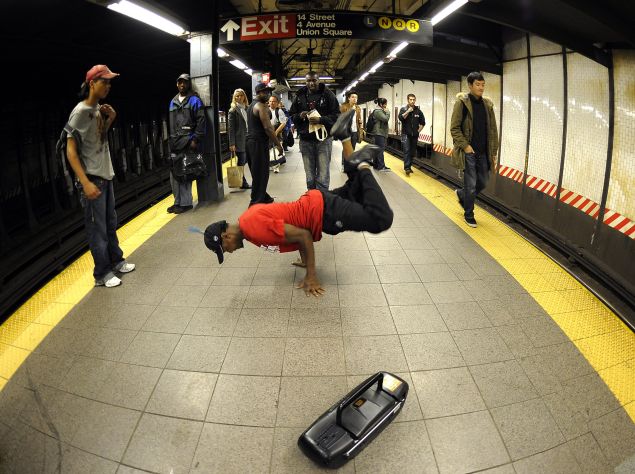 A subway performer dancing on a platform. (Timothy A. Clary/AFP/Getty Images)