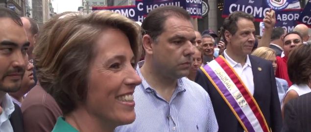 Zephyr Teachout blocked by Gov. Andrew Cuomo lieutenant Joseph Percoco while attempting to speak to the governor at a parade.