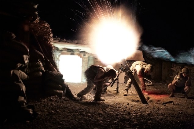 US Army soldiers from the 10th Mountain  Division fire mortar rounds from their Combat Outpost during a surprise attack by Taliban fighters. AFGHANISTAN. Kunar, 2012. (Photo by Sebastiano Tomada)