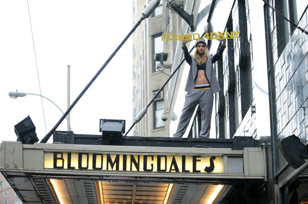 Ms. Delevingne on the awning. (Photo via Getty)