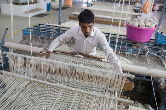 Munir Ahmad works at Raj Overseas, West Elm's Indian supplier of Fair Trade rugs, in the first-ever Fair Trade rug factory (photograph by Theodore Kaye © 2014 Fair Trade USA)