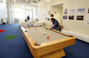 A Google employee plays pool at Google's headquarters.