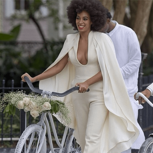 Solange walks her bicycle while wearing a Stéphane Rollande jumpsuit. (Photo via instagram.com/beyonce)