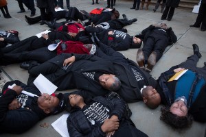 Council members participate in a "die-in" outside City Hall to protest the Eric Garner grand jury decision. (Photo: William Alatriste/NYC Council)
