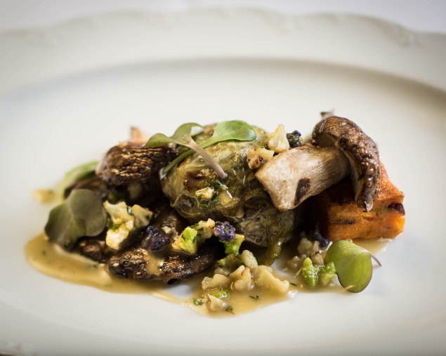 Porcini mushrooms with duxelle stuffed cabbage, sweet potato gratin and lemon thyme jus. (Photo by Francesco Sapienze)