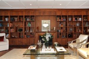 Antiqued, pan European titles occupy a walnut bookcase. 