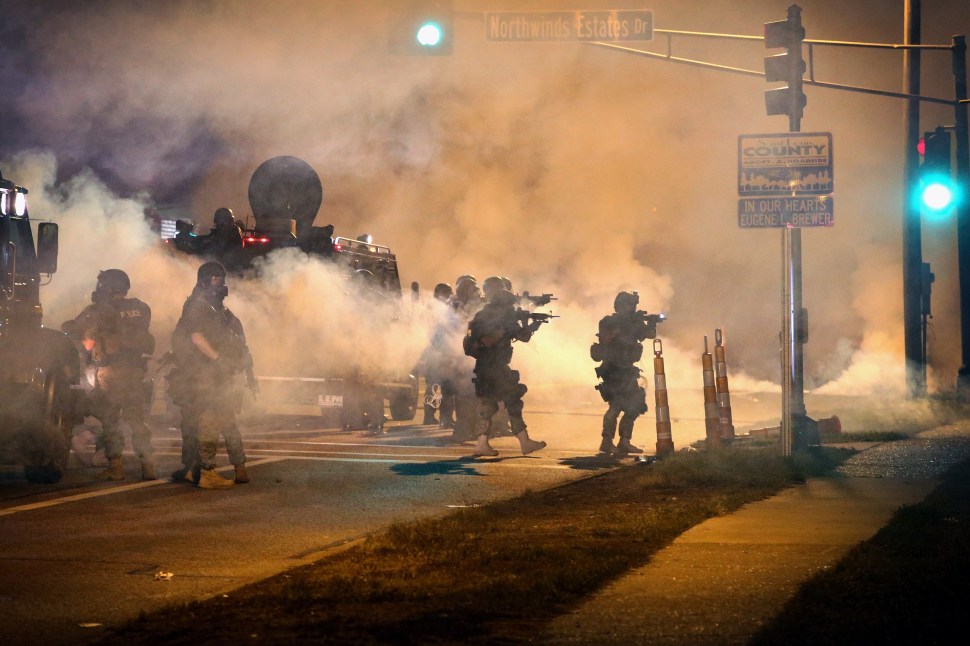 Police attempt to control demonstrators protesting the killing of Michael Brown. (Getty/Scott Olson)