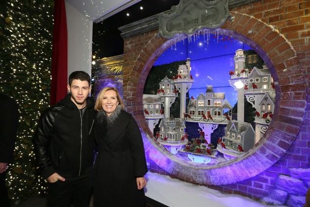 Nick Jonas and Liz Rodbell celebrating the Lord & Taylor windows. (Photo via Getty)