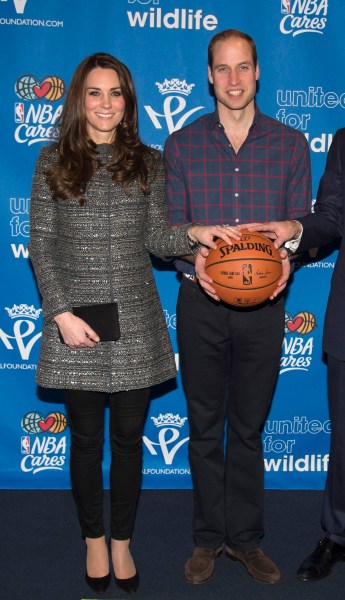 The Duchess and Duke looking excited, if a little trepidatious, to hold a basketball. (Photo via Getty)