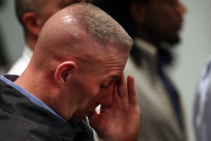 A police officer pauses as he listens to Police Commissioner Bill Bratton address the media on Saturday. (Photo: Spencer Platt/Getty Images)