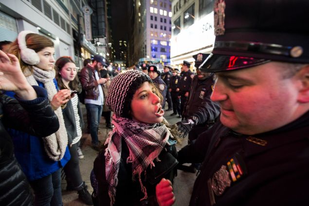 A protester confronted a member of the NYPD at a protest last year over the Eric Garner decision.