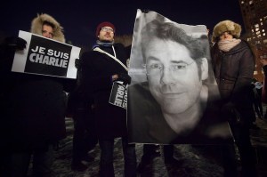 Supporters hold a banner showing the Charlie Hebdo editor at a march in Union Square. (Flickr)