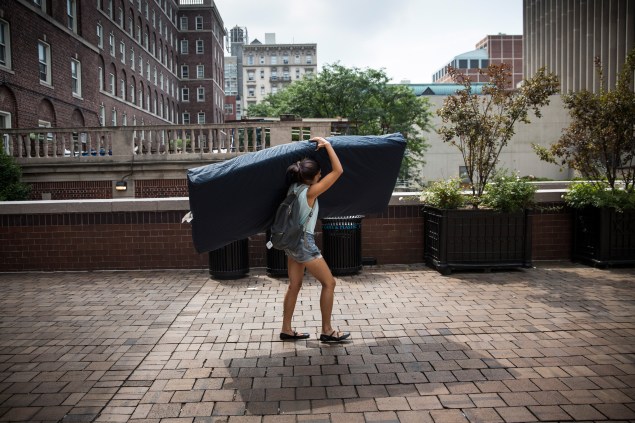 Emma Sulkowicz, a senior visual arts student at Columbia University, carries a mattress in protest (Photo by Andrew Burton/Getty Images)