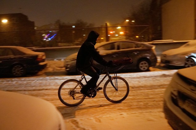 These guys deserve higher-than-normal tips for biking during inclement weather. (Photo: Getty Images)