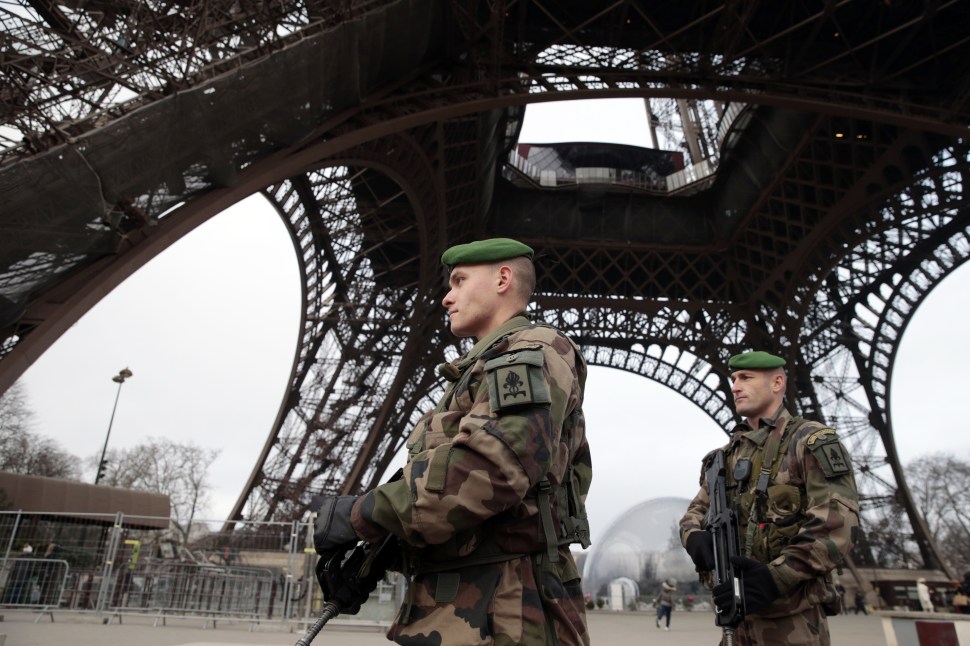 French soldiers patrol in front of the Eiffel Tower on January 7, 2015 in Paris as the capital was placed under the highest alert status after heavily armed gunmen shouting Islamist slogans stormed French satirical newspaper Charlie Hebdo in the deadliest attack in France in four decades. (JOEL SAGET/AFP/Getty Images)