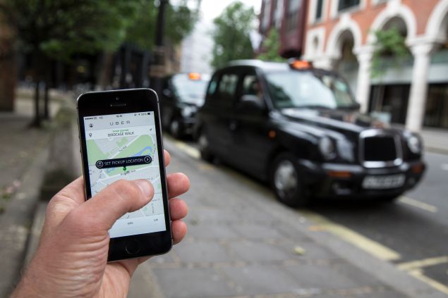 The Uber app. (Photo by Oli Scarff/Getty Images)