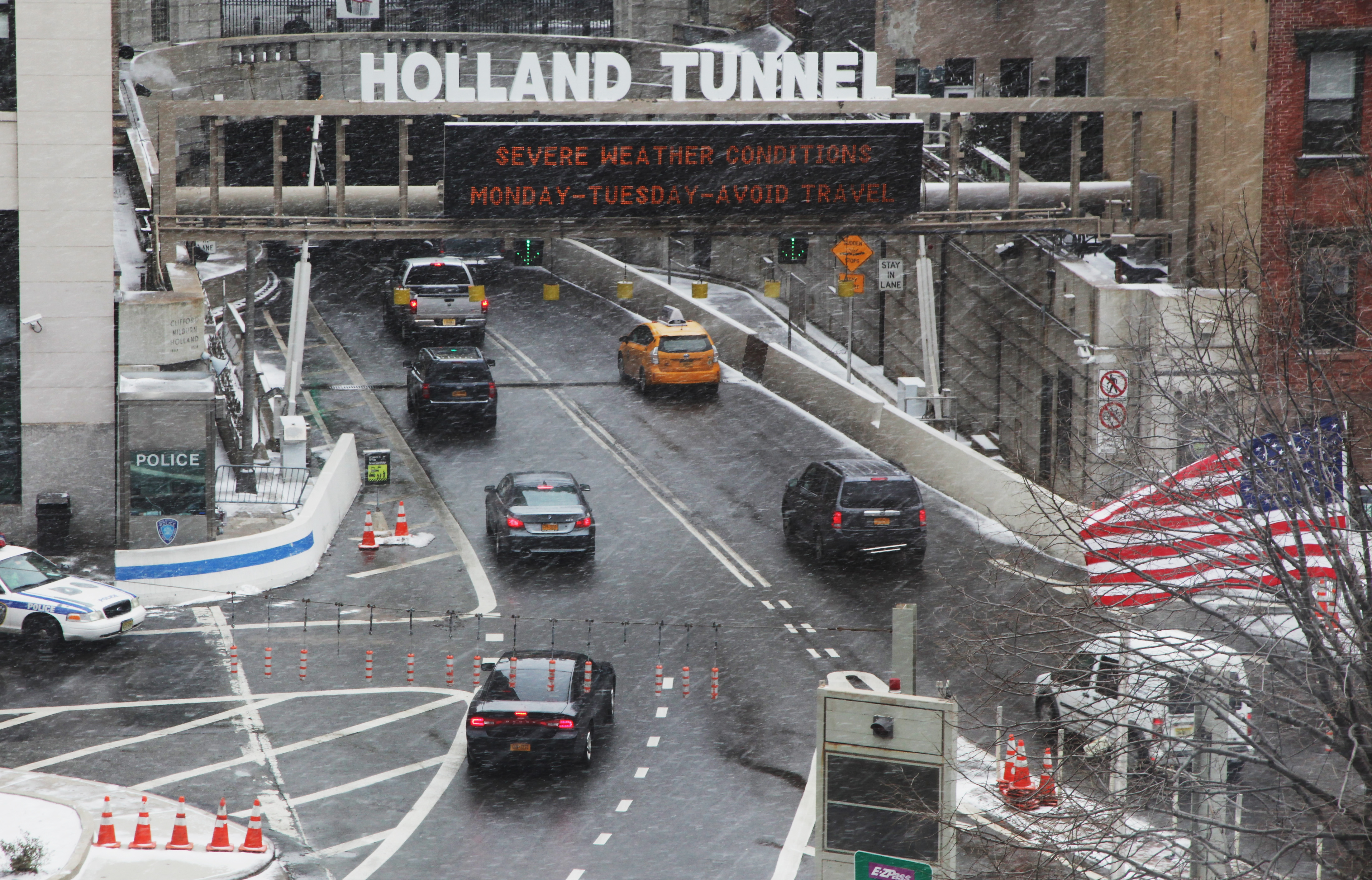 Cars travel into the Holland Tunnel under a sign warning of severe weather.(Photo: Preston Rescigno/Getty Images)