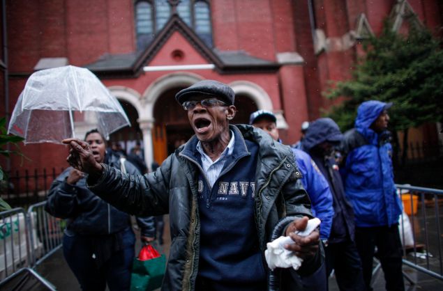 An enraged man at Akai Gurley's funeral in 2014.