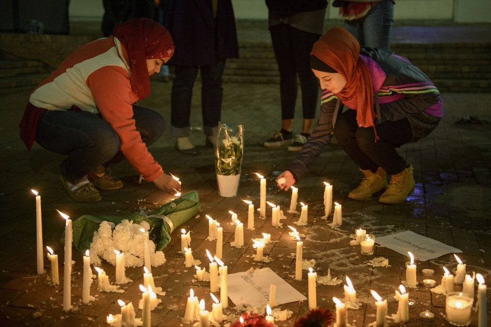 People stand by as a makeshift memorial is made after vigil at the University of North Carolina following the murders of three Muslim students on February 11, 2015 in Chapel Hill, North Carolina. (Photo: Brendan Smialowski/ Getty Images)