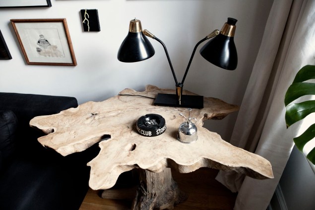 A teak root table with an antique lamp. Photo: Celeste Sloman/New York Observer