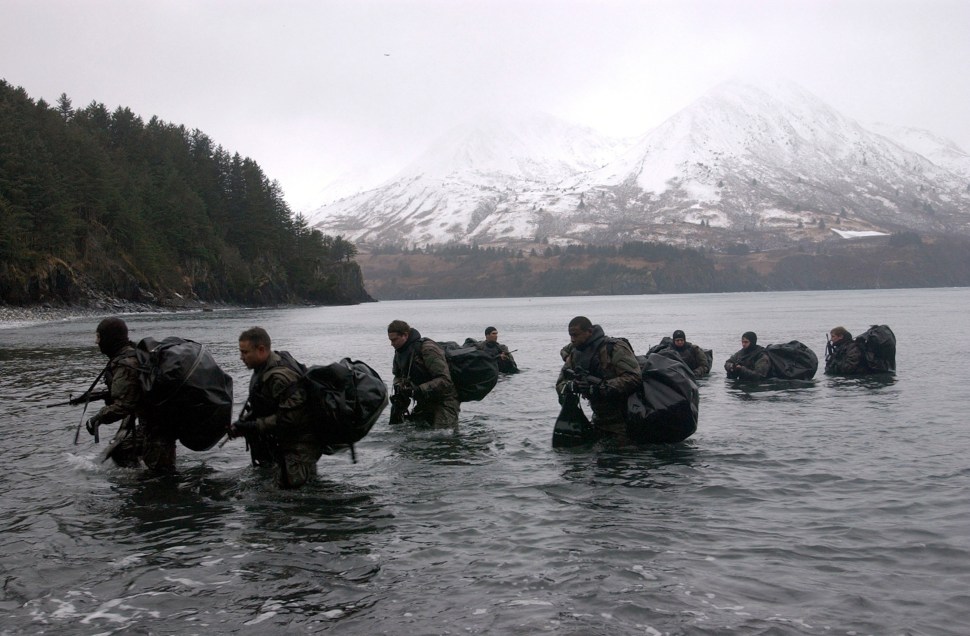 Navy SEALs perform Advanced Cold Weather training to experience the physical stress of the environment and how their equipment will operate, or even sound, in adverse conditions December 14, 2003 in Kodiak, Alaska. Navy SEALs are maritime special operations forces that strike from the sea, air and land. They operate in small numbers, infiltrating their objective areas by fixed-wing aircraft, helicopters, Navy surface ships, combatant craft and submarines. SEALs have the ability to conduct a variety of high-risk missions, utilizing unconventional warfare, direct action, special reconnaissance, combat search and rescue, diversionary attacks and precision strikes. (Photo by Photographer's Mate 2nd Class Eric S. Logsdon/U.S. Navy via Getty Images)