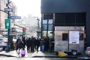People lining up on the corner of West 35th Street and 9th Avenue for their kosher lunch