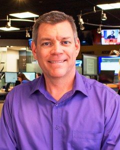 Mark Moran, the voice of Audible.com's production of the New York Times AudioDigest, pictured at his day job, Phoenix public radio station KJZZ (Tricia Moore).