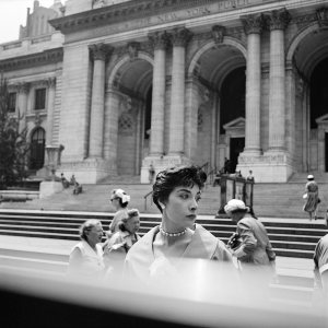 A woman poses in front of the New York Public Library (©Vivian Maier/Maloof Collection, Courtesy Howard Greenberg Gallery, New York)