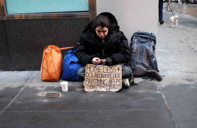 A homeless woman begs for help on the street (Photo: Jewel Samad for AFP/Getty Images)