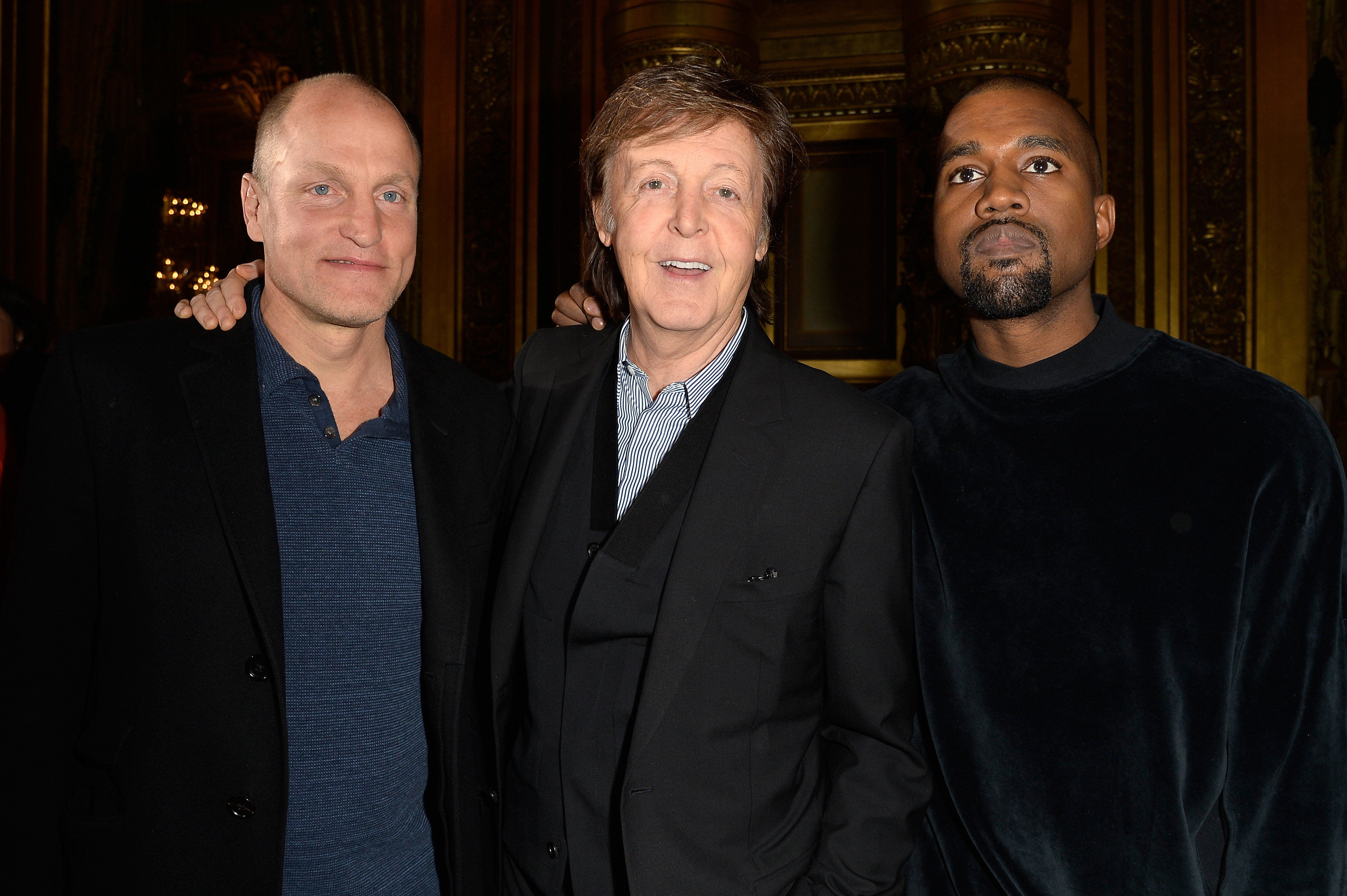 Woody Harrelson, Paul McCartney and Kanye West at the Stella McCartney show (Photo: Getty).