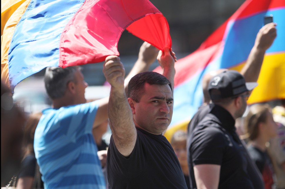  A man carries an Armenian flag during a march on the 99th anniversary of the Armenian Genocide, calling for recognition and reparations, on April 24, 2014 in Los Angeles, California. Relations between Turkey and Armenia, a former Soviet republic, remain split over the issue of genocide which, according to Western historians, resulted in the massacre of as many as 1.5 million Armenians and eviction of 500,000 others from land occupied by their ancestors for 2,500 years. Earlier this month, the Republic of Turkey condemned a U.S. Senate committee resolution branding the massacre of Armenians by Ottoman forces during World War One as genocide and warned that such a step could harm Turkish-American ties. (Photo by David McNew/Getty Images)