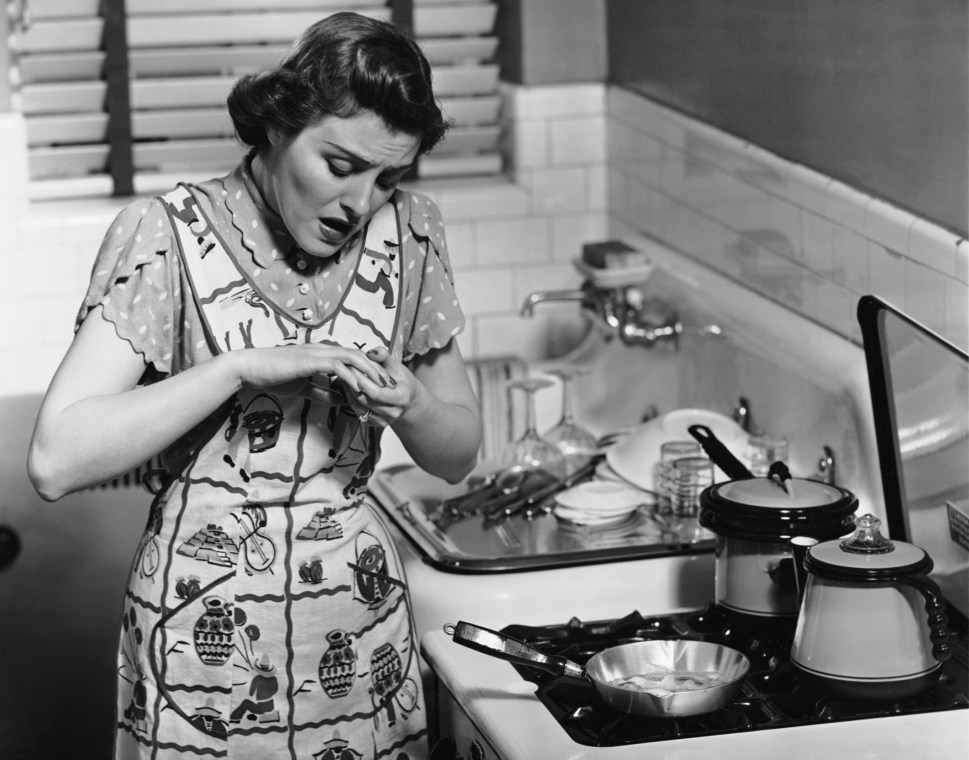 CIRCA 1950s: Woman at stove after burning hand. (Photo by George Marks/Retrofile/Getty Images)