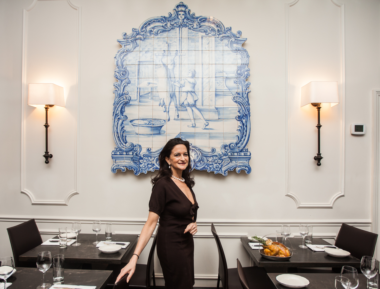 Ms. Farkas with a Portuguese tile mural in her restaurant (Photo: Emily Assiran/New York Observer).