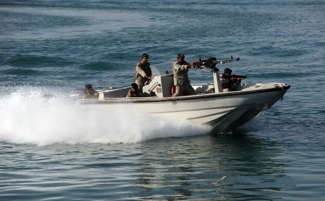 Iranian Army soldiers stand guard on a military speed boat. (ALI MOHAMMADI/AFP/Getty Images)