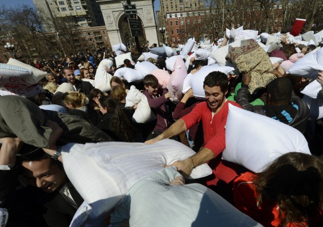 People hit each other with pillows as they take part in the world's annual Pillow Fight Day in Washington Square Park in New York. (Photo: Timothy A. Clary, Getty Images)