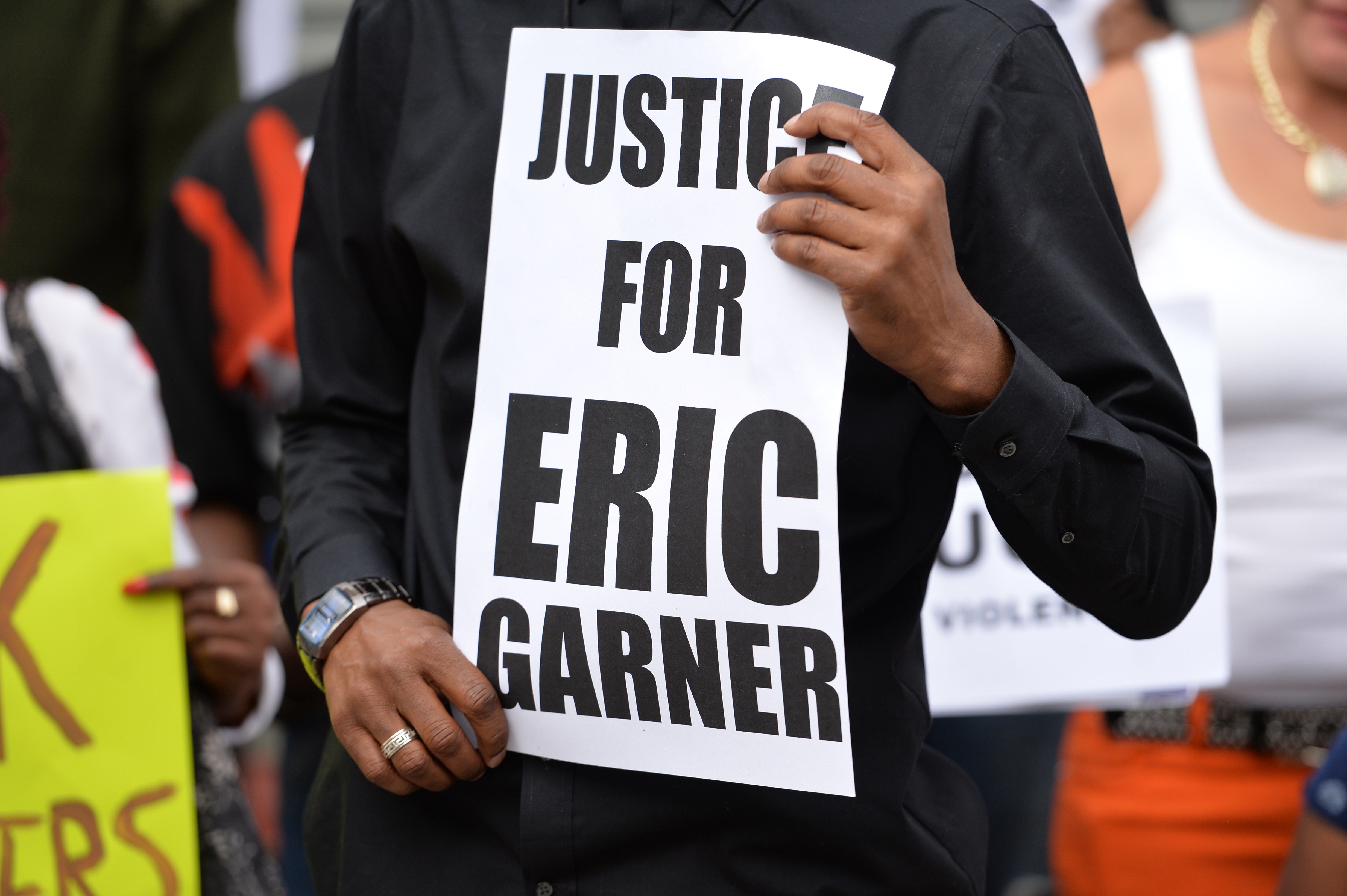 A protester holding a sign demanding justice for Eric Garner.
